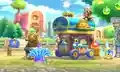 Kirby standing in front of the amiibo statue in the village in Team Kirby Clash Deluxe