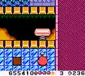 A bumper attached to a spring from Kirby Tilt 'n' Tumble, hanging over a bottomless pit