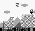 Kirby jumping over a bottomless pit from Kirby's Dream Land 2