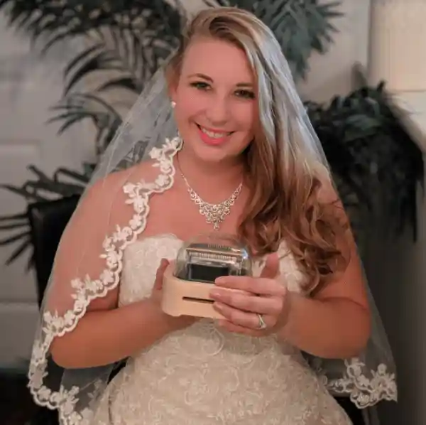 The bride, Emily Gvino, is holding the first generation Muro Box-N20 Lite music box, which was purchased by her father as her wedding gift.