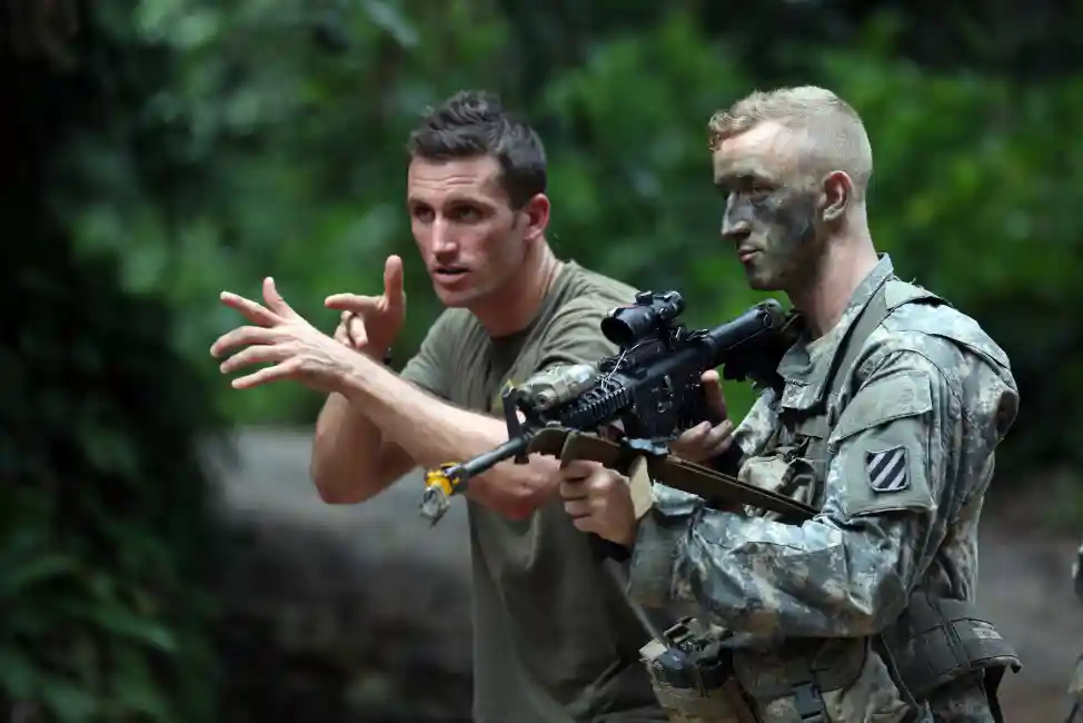 A French soldier teaches squad movement drills to a U.S. Soldier assigned to Bravo Company, 3rd Battalion, 7th Infantry Regiment, 2nd Infantry Brigade Combat Team, 3rd Infantry Division, at the Jungle Warfare School in Gabon, June 8, 2016. Soldiers attended the French Jungle Warfare School as part of U.S. Army Africa's exercise Central Accord 2016, an annual, combined, joint military exercise that brings together partner nations to practice and demonstrate proficiency in conducting peacekeeping operation. (U.S. Army photo by Sgt Henrique Luiz de Holleben)