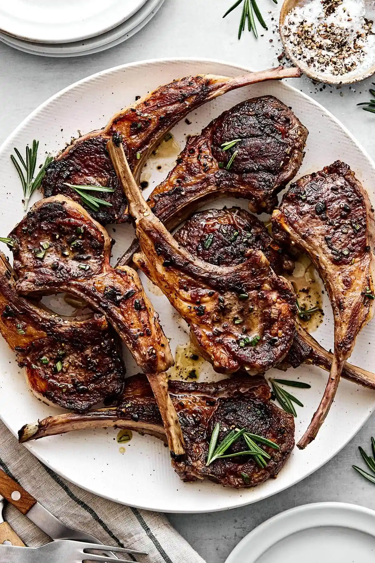 A plate of rosemary grilled lamb chops for holiday dinners like Easter or summer cookouts.