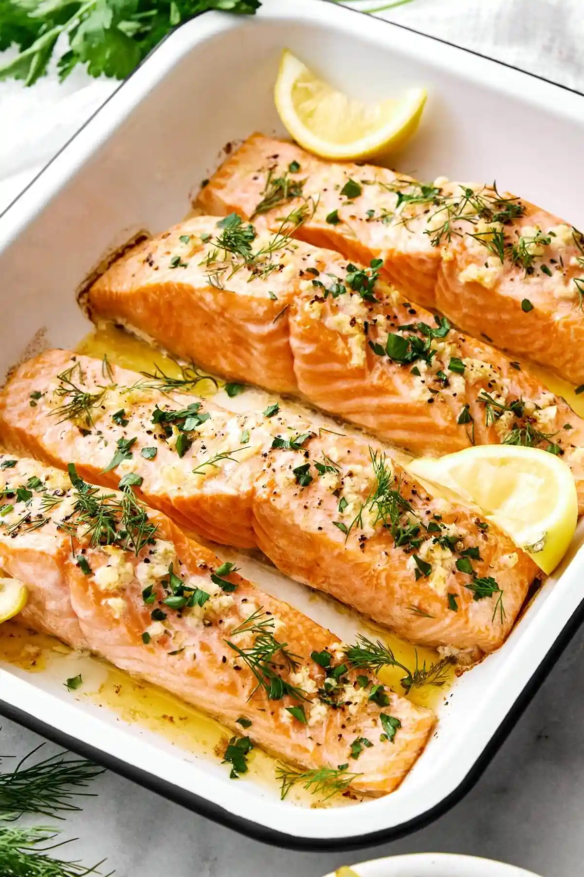 A baking tray of baked salmon.