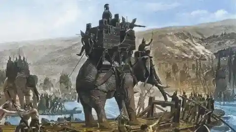 An illustration of an elephant with soldiers crossing a river