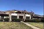 EF1 damage example -- Sections of roofing are removed from the home, leaving the internal decking exposed.