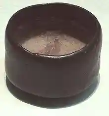 Photo of a tea bowl, dark-coloured, humble, and asymmetric