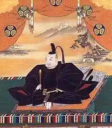 Painting of a mediaeval Asian man seated and dressed in splendour