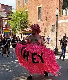 Proponent of pronoun "they" representing someone who doesn’t identify with a specific gender, at the Boston Pride parade.