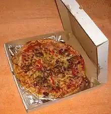 An open pizza box with a pizza inside
