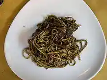 Three-sided white plate containing linguini