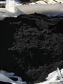 Biochar in a white tarp