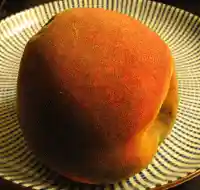 Time-lapse photography sequence of a peach becoming progressively discolored and disfigured