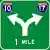 [road sign: green square with a white arrow that goes up then splits with one arrow bending left and one bending right; below the arrow are the words '1 MILE'; above the left is an interstate logo with the number '10'; above the right is an interstate logo with the number '17']