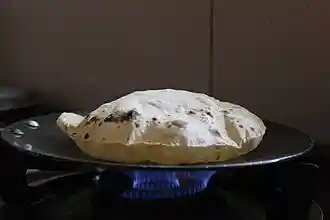 A roti being baked on a tava