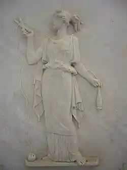 Atropos cutting the thread of life. Modern Greek low relief.