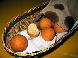 Fried balls of dough in a basket.