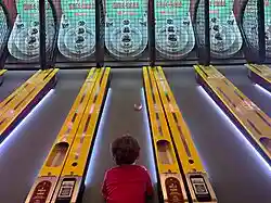 Child playing skee-ball.