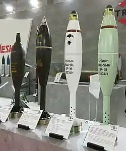 A group of M120 Rak mortar shells. The dark green shells on the left are stencilled to indicate a filling of TNT