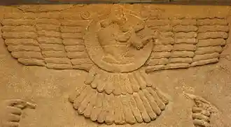 Male figure in an Assyrian winged sun emblem (Northwest Palace of Nimrud, 9th century BC).
