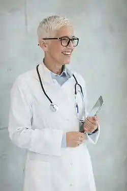 Photo of a female doctor with white hair and glasses