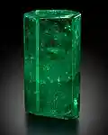 Large, di-hexagonal prismatic crystal of 1,390 carats uncut with a deep green color. It is transparent and features few inclusions in the upper 2/3, and is translucent in the lower part.