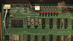 A close-up of the top-left portion of the Apple I motherboard. The chips are arranged in a grid. One chip is larger than the rest and is placed horizontally rather than vertically.