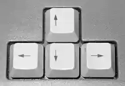 A cluster of four square keyboard keys in an inverted-T arrangement marked with up, left, down, and right arrows.