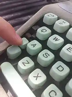 a finger depresses the shift-lock lever