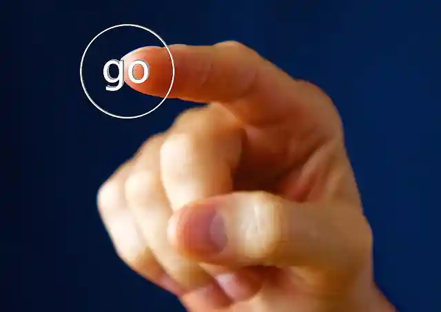Finger pushing a go button